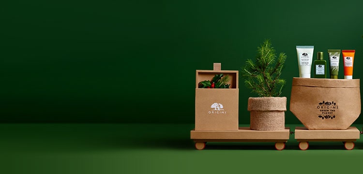 Origins Green The Planet set and pine tree seedling are placed on a carton train. 